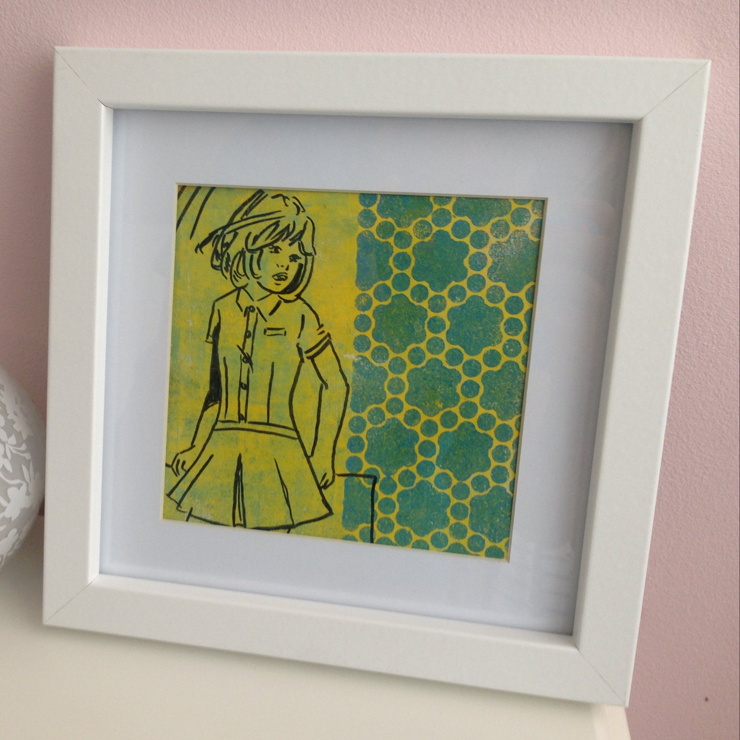 Framed yellow, green and black monoprint of a vintage inspired female character