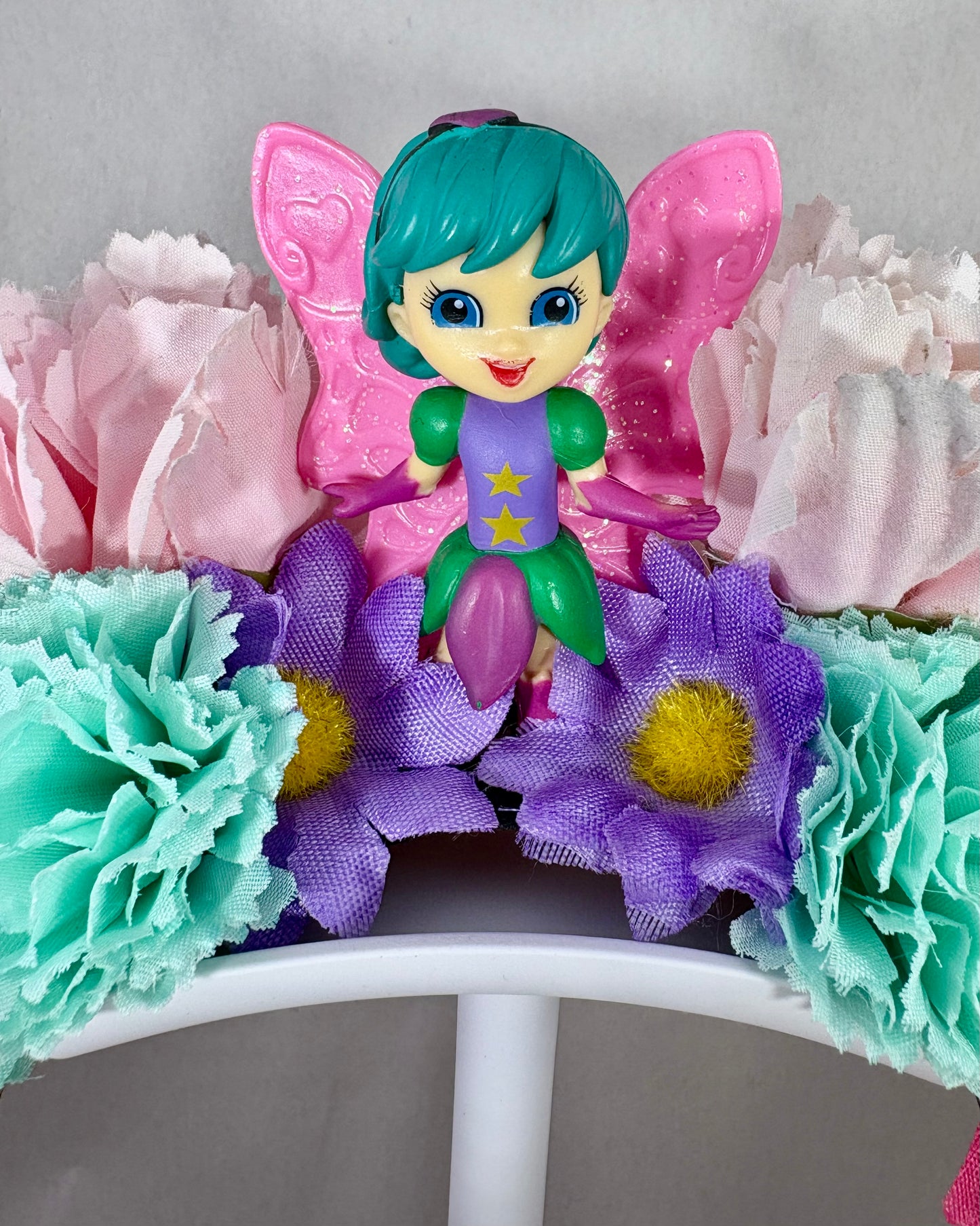 Close up of Colourful headband with flowers and a fairy figure
