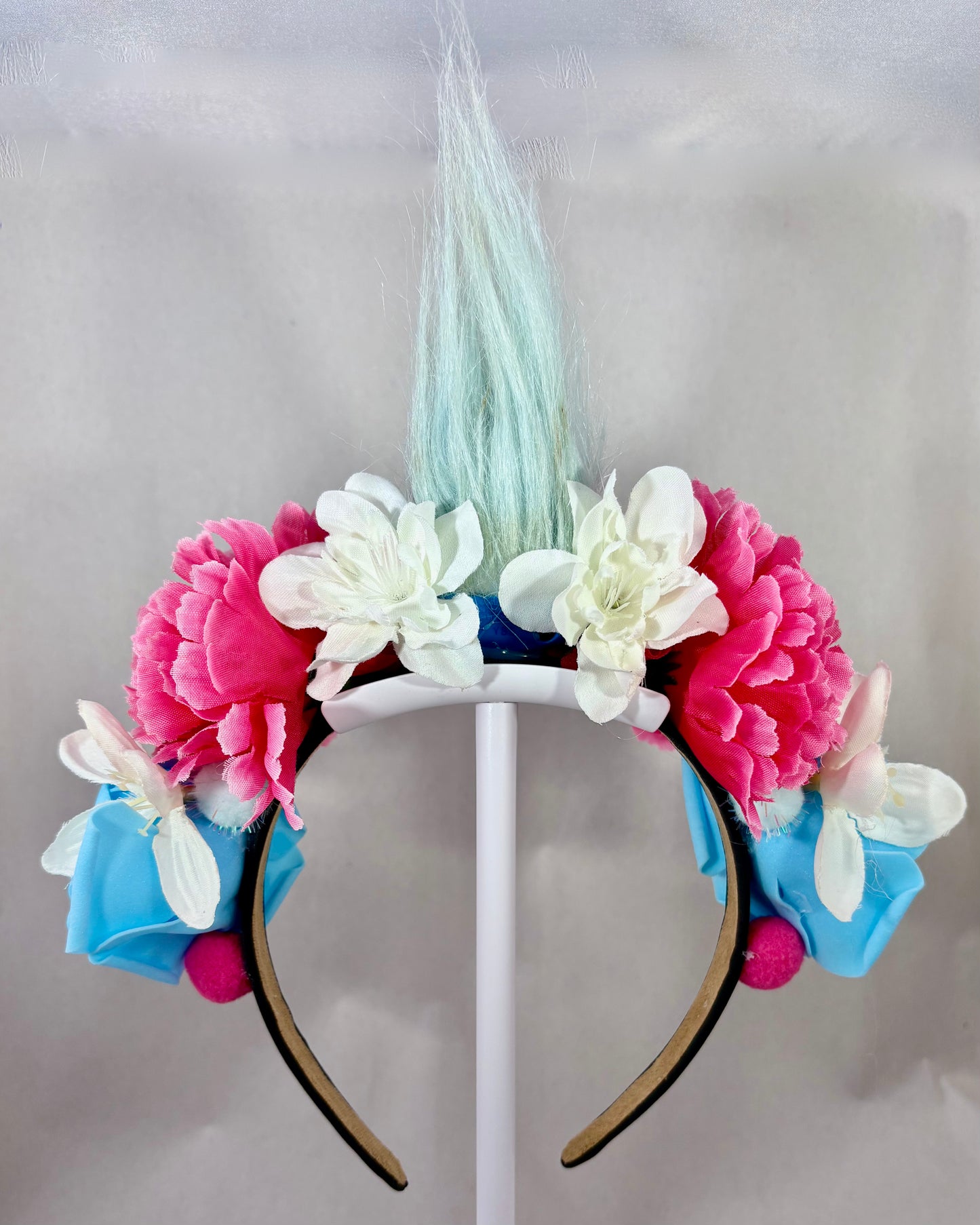 Back of Festival Crown with Blue Troll head and blue and pink flowers