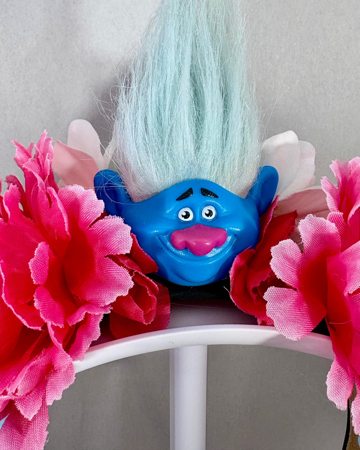 Close up of Festival Crown with Blue Troll head and blue and pink flowers