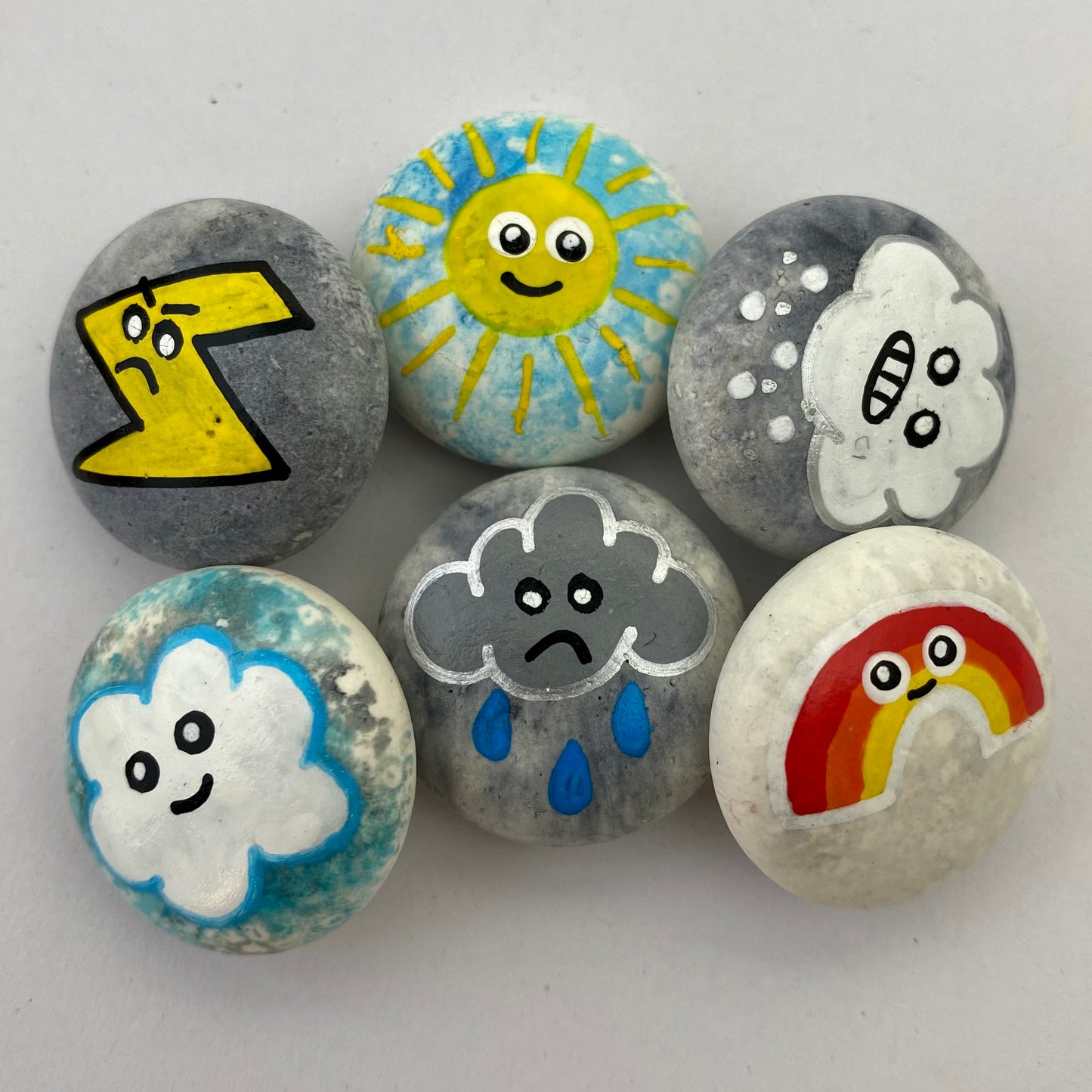 6 small hand painted weather themed pebbles