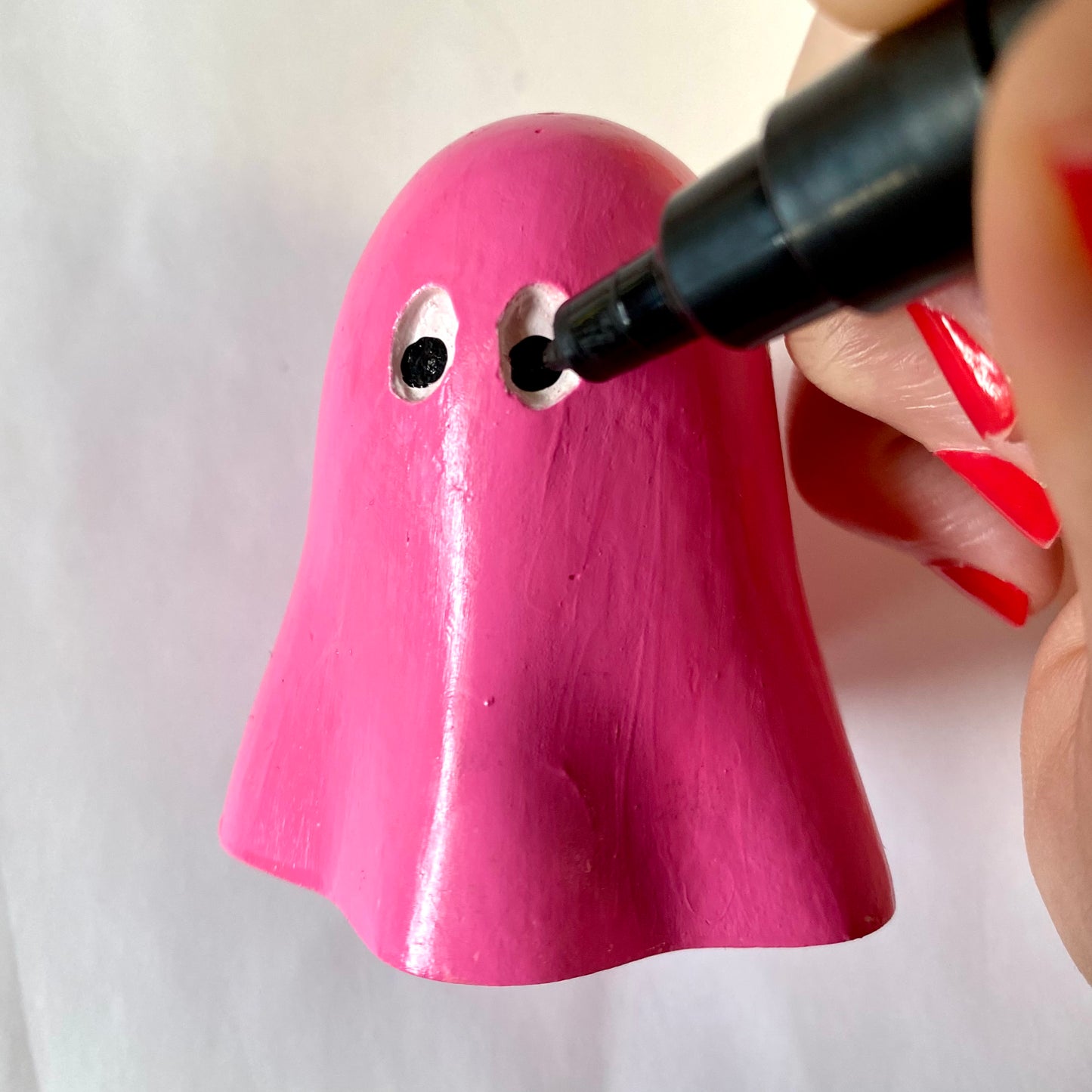 Hand Cast Plaster Ghost statue being painted pink.