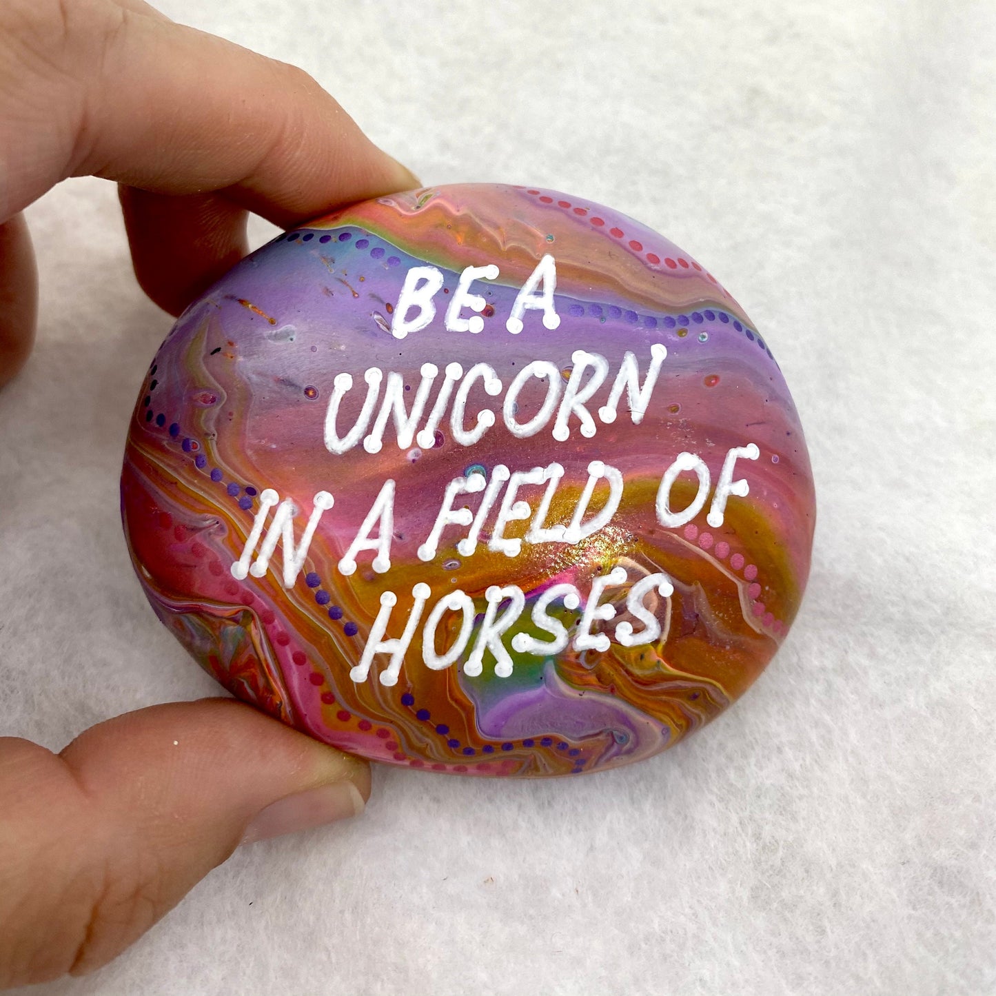 Colourful Hand painted Stone with the words Be A Unicorn in a Field of Horses