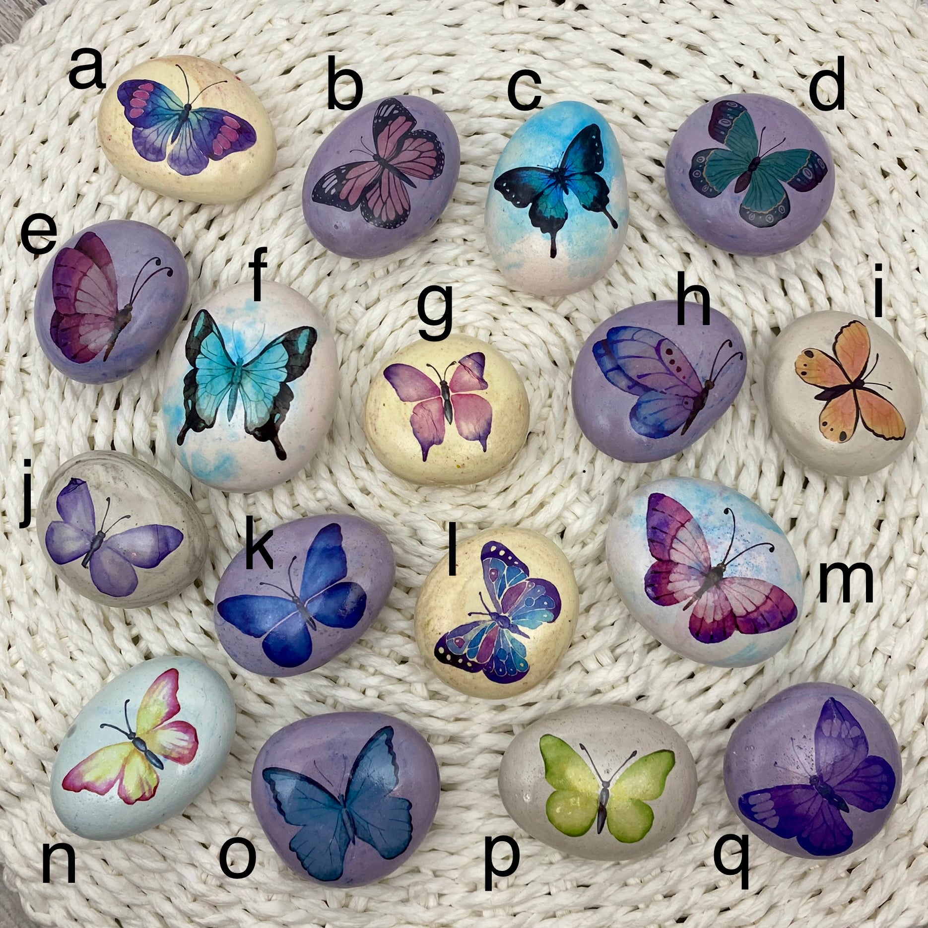 Marbled pebbles with butterfly decals on