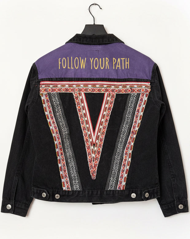 Black jacket with purple and red geometric design and 'Follow Your Path' text on a white background
