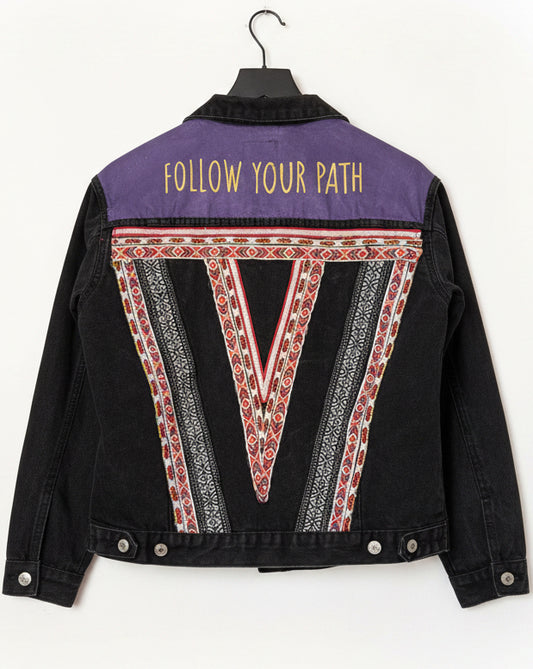 Black jacket with purple and red geometric design and 'Follow Your Path' text on a white background