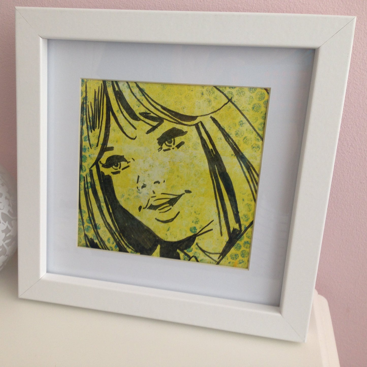 Framed yellow, green and black monoprint of a vintage inspired female character