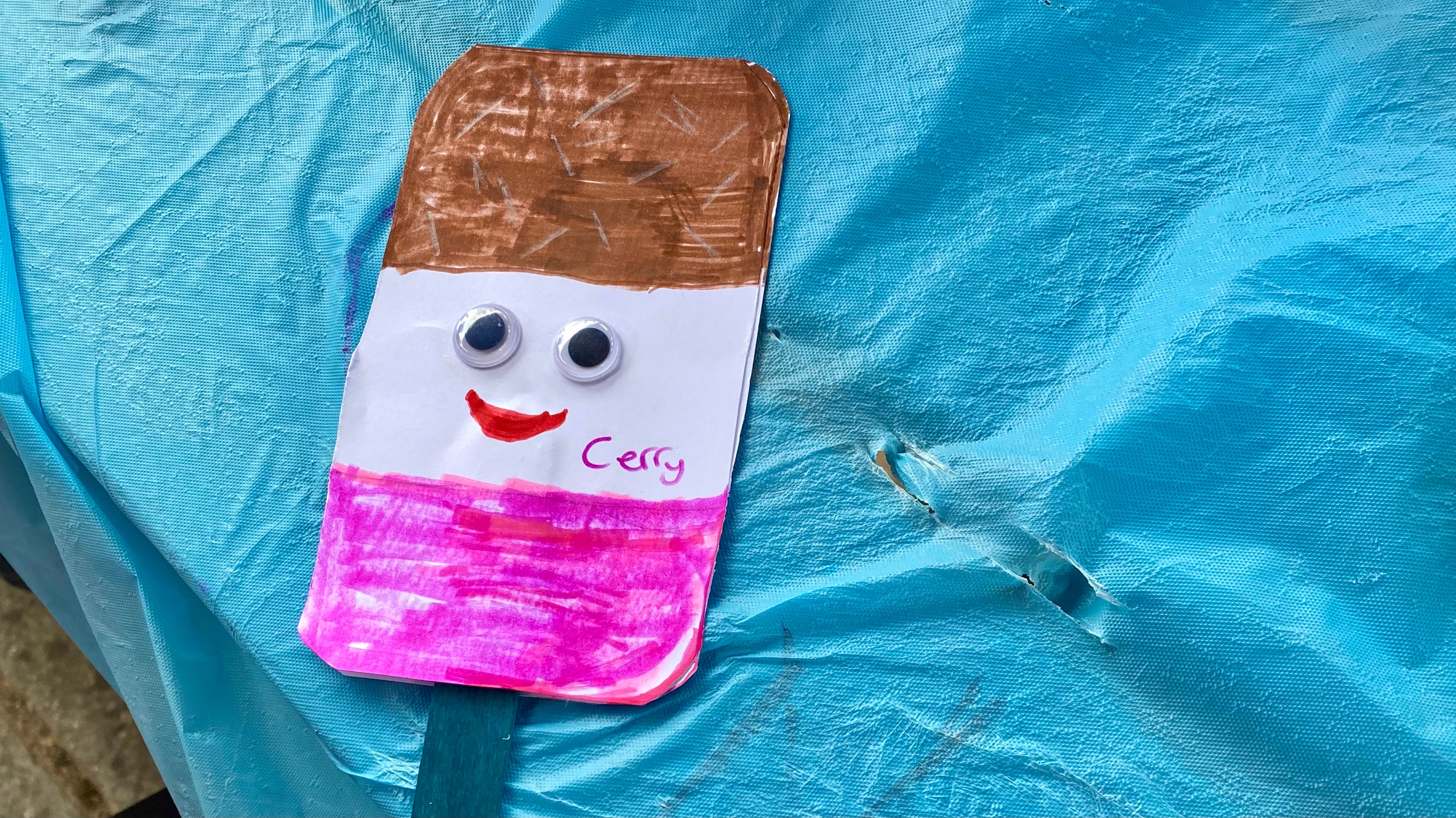 Neapolitan style ice lolly card with a smiley face with gooley eyes. Complete with a blue wooden stick and the name Cerry written on.
