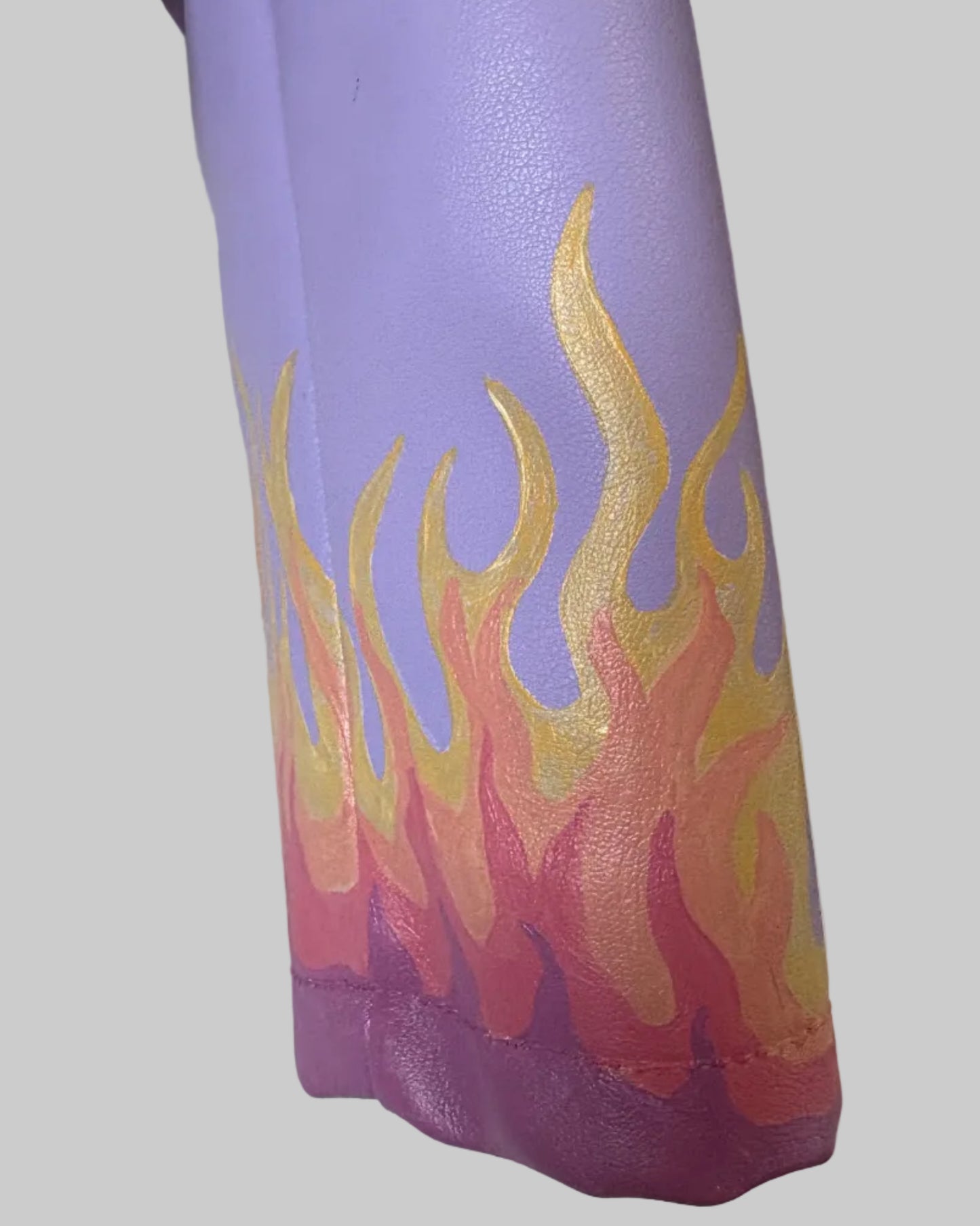 Close up of cuff on Lilac PU leather jacket with painted flame design