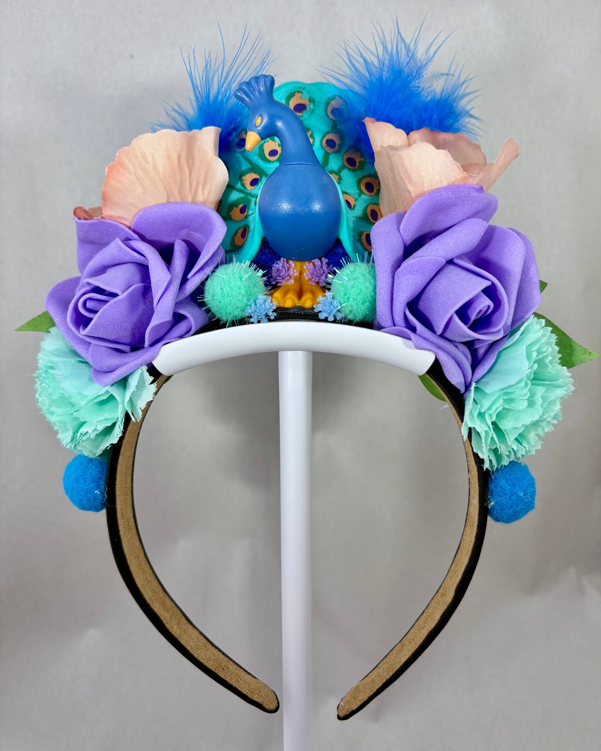 Colourful headband with flowers and feathers and a peacock figure