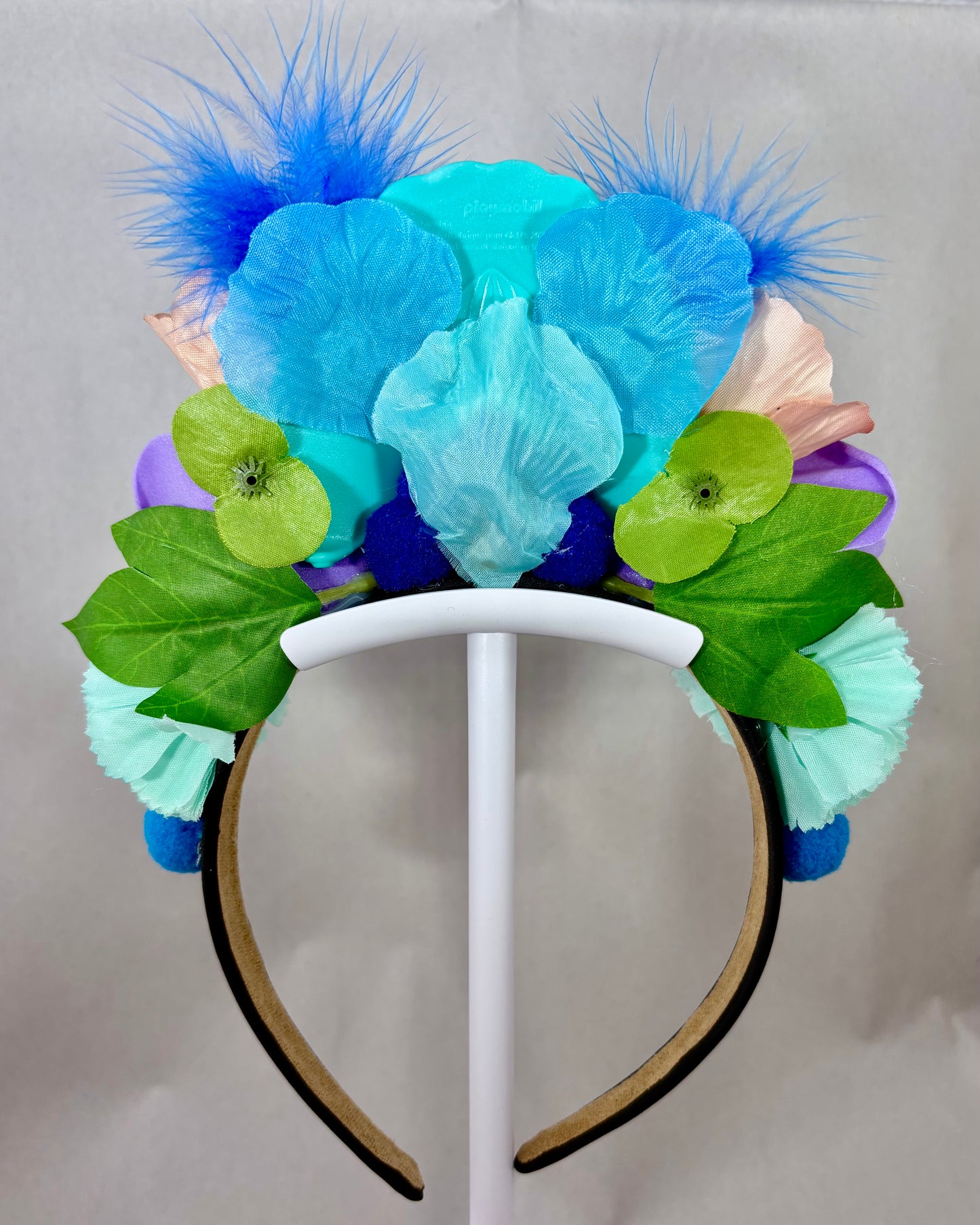 Back of Colourful headband with flowers and feathers and a peacock figure