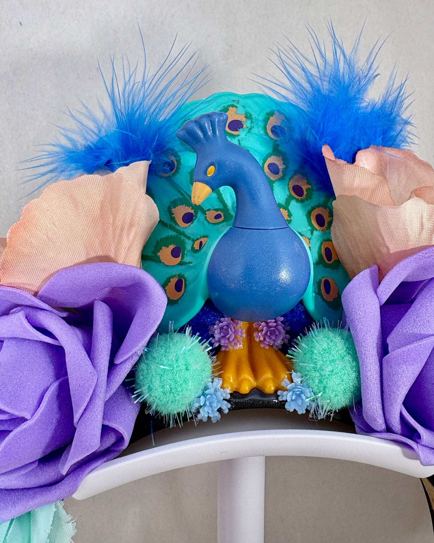Close up Colourful headband with flowers and feathers and a peacock figure