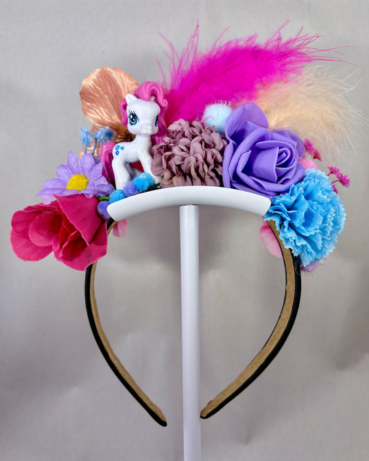 Colourful headband with flowers and a small pony figurine