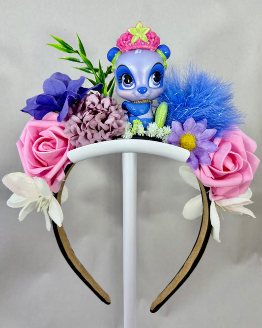 Colourful floral headband with a small purple panda toy figure