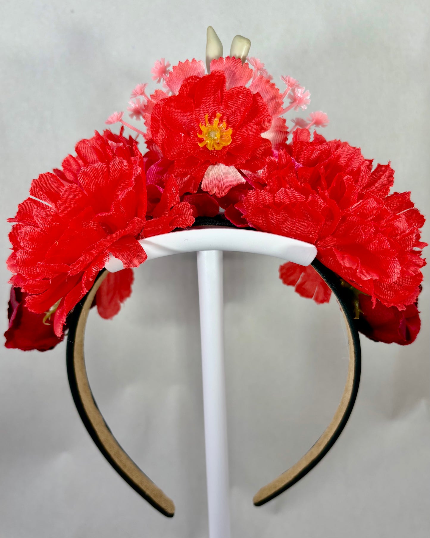 Back of a Decorative headband with red and pink flowers 