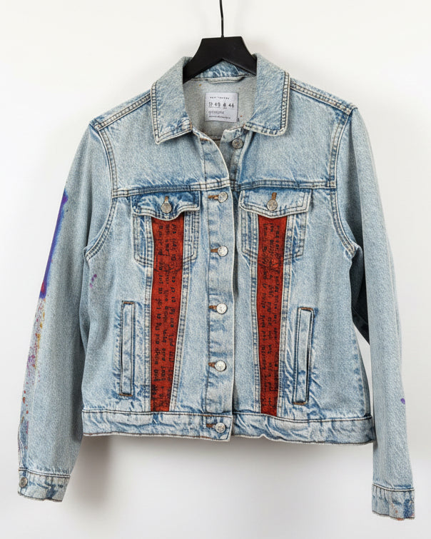 Front of hand-painted UK size 12 denim jacket with two vertical orange panels, covered in bird-themed affirmations in neat hand-painted lettering, including phrases like ‘Spread your wings and fly as high as you can’ and ‘Be strong with a heart wide open.’ One-of-a-kind upcycled wearable art.