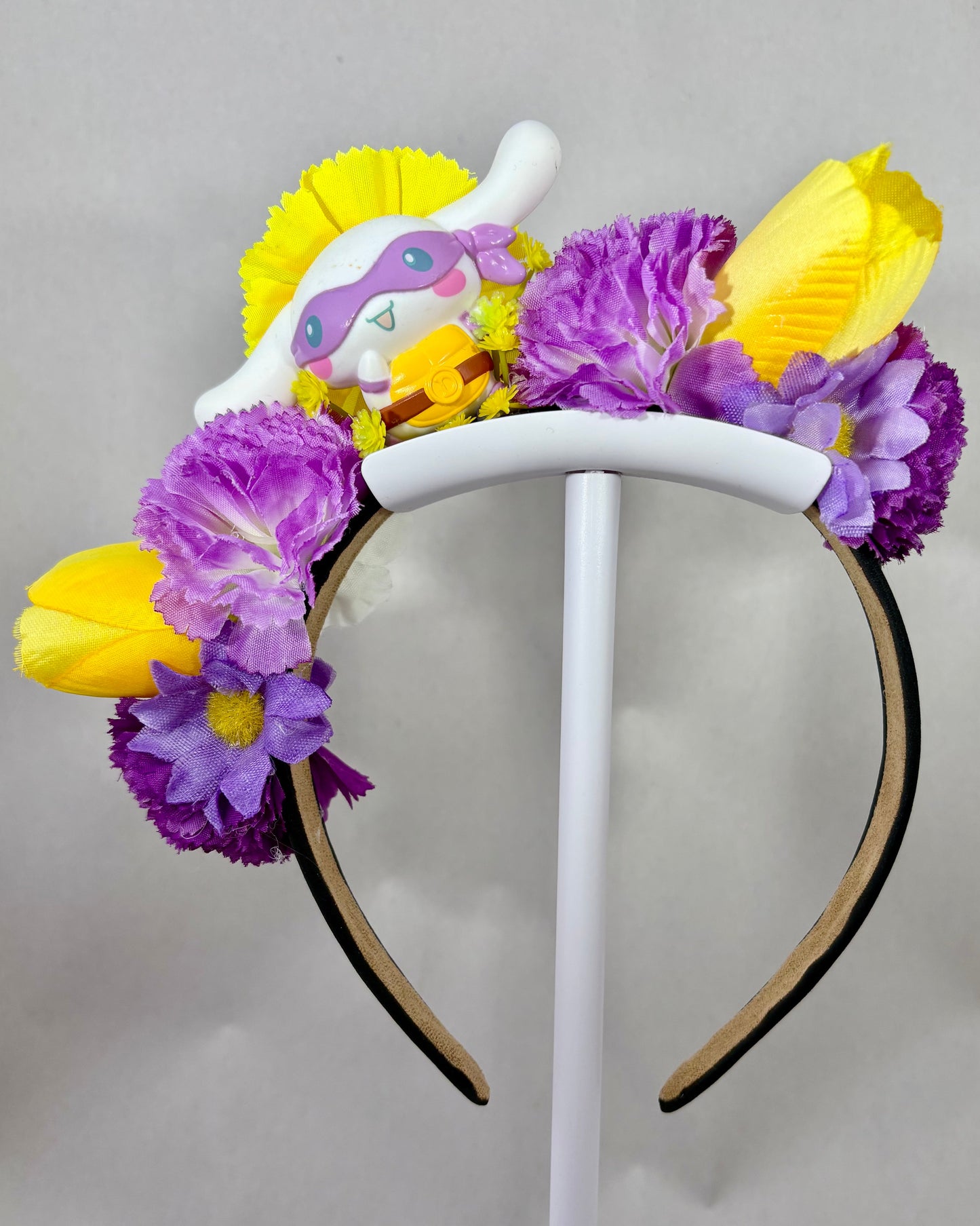 Floral headband with white puppy toy and purple and yellow flowers
