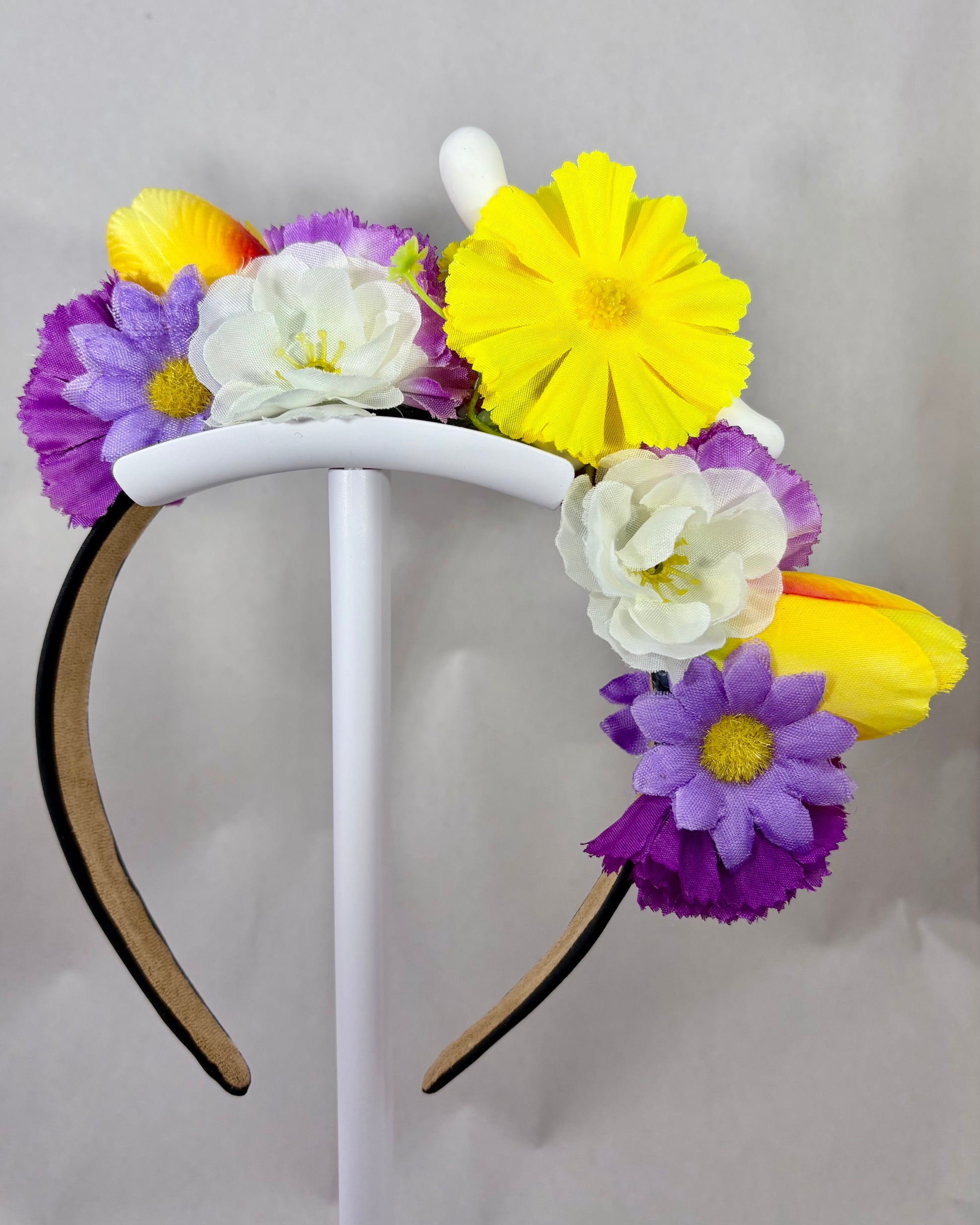 Back of Floral headband with white puppy toy and purple and yellow flowers