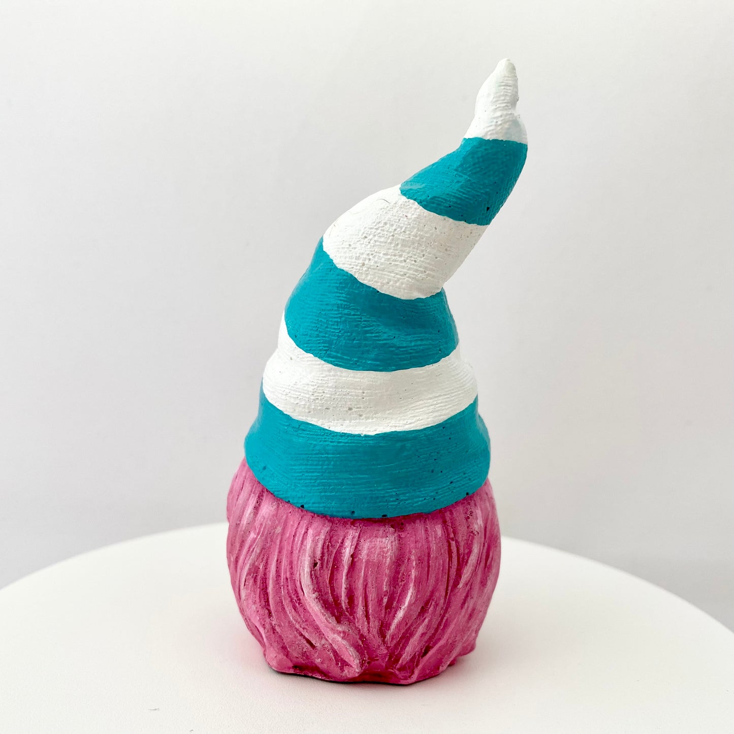 Hand painted Gonk statue with pink beard and teal and white striped hat  Edit alt text