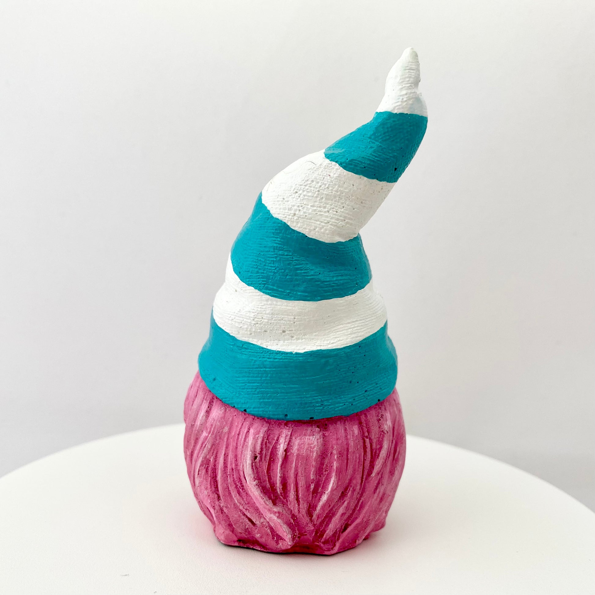 Hand painted Gonk statue with pink beard and teal and white striped hat  Edit alt text