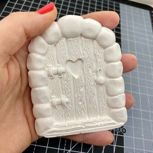 Hand Cast Plaster Fairy Door ready to paint. Held to show size.