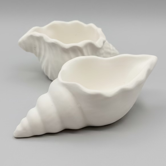 Side view of 2 white hand Cast Plaster Shell Pots ready to paint.