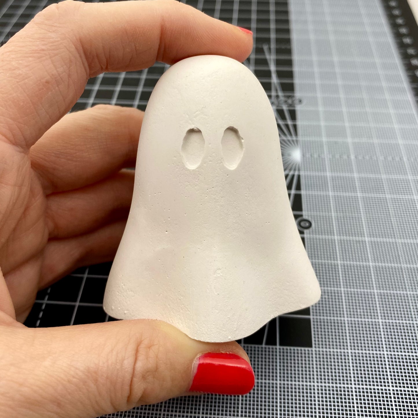 Hand Cast Plaster Ghost statue ready to paint. Being held to show size.