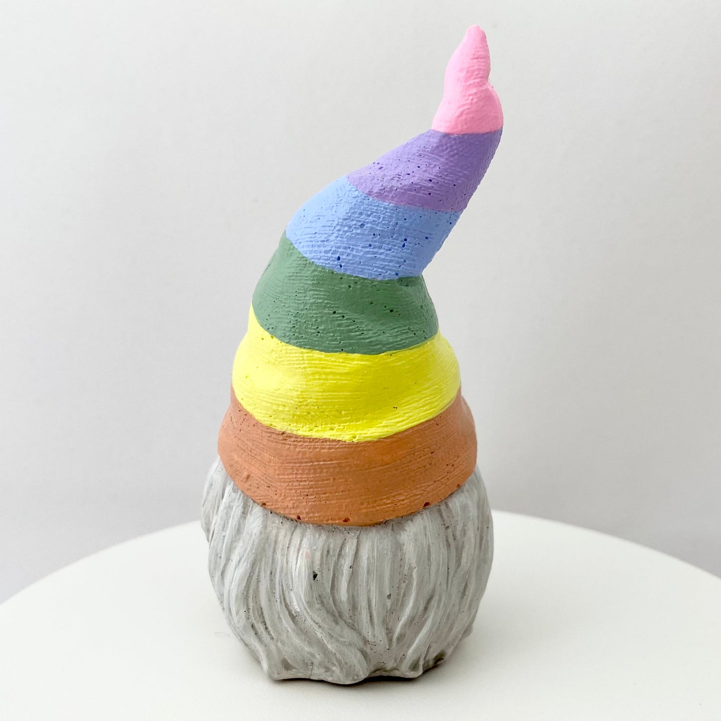 Hand painted Gonk statue with pastel rainbow striped hat