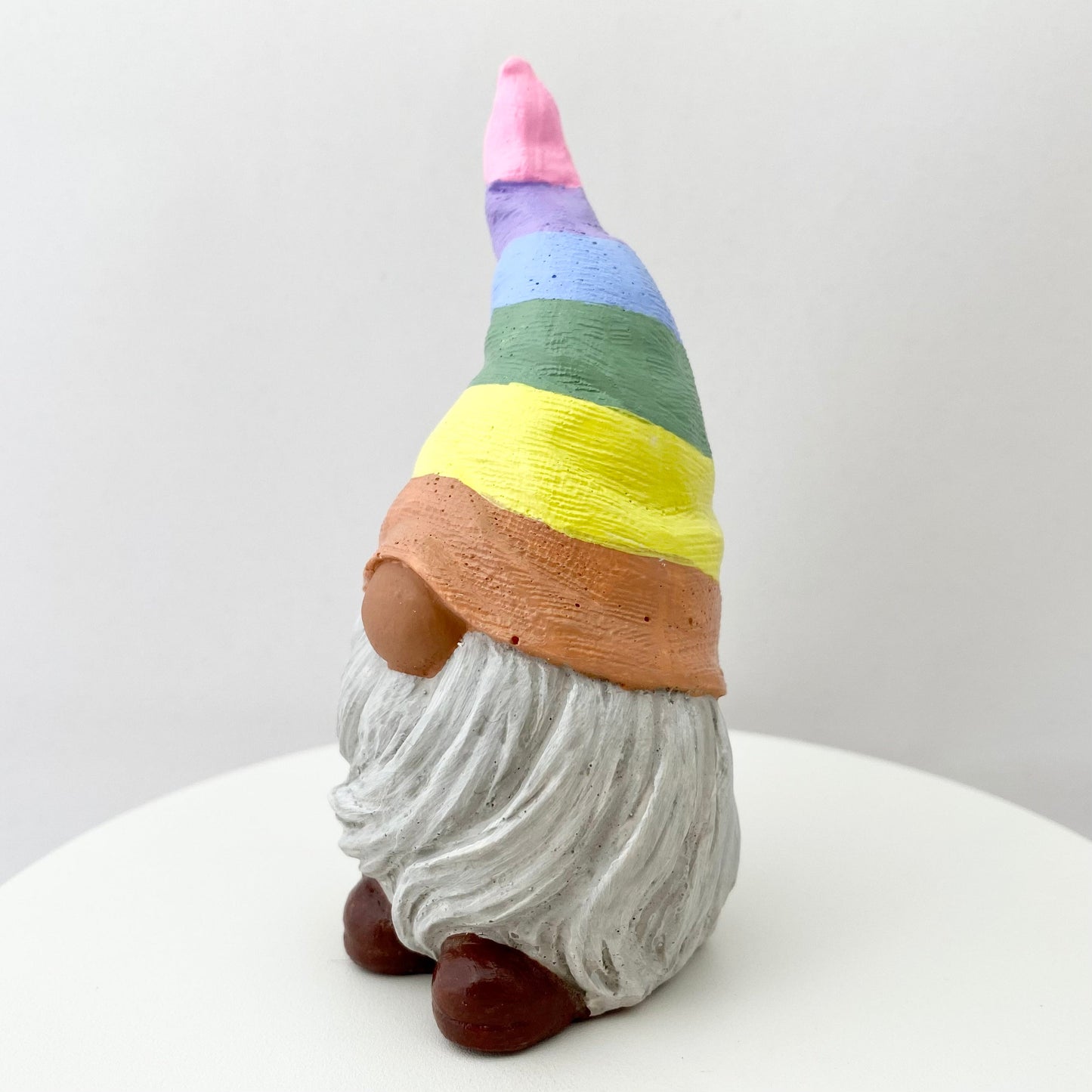 Hand painted Gonk statue with pastel rainbow striped hat