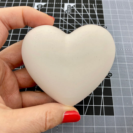 Hand Cast Plaster Heart Stone ready to paint. Held to show size.