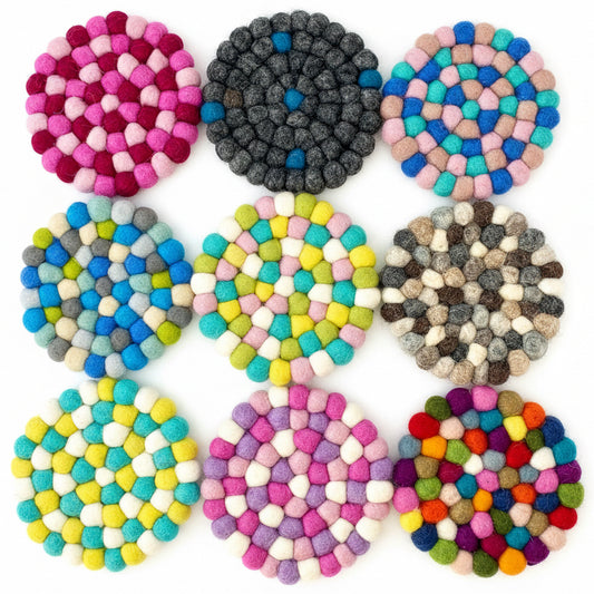 9 Coaster sized Mats made from Felt Balls in different colours.
