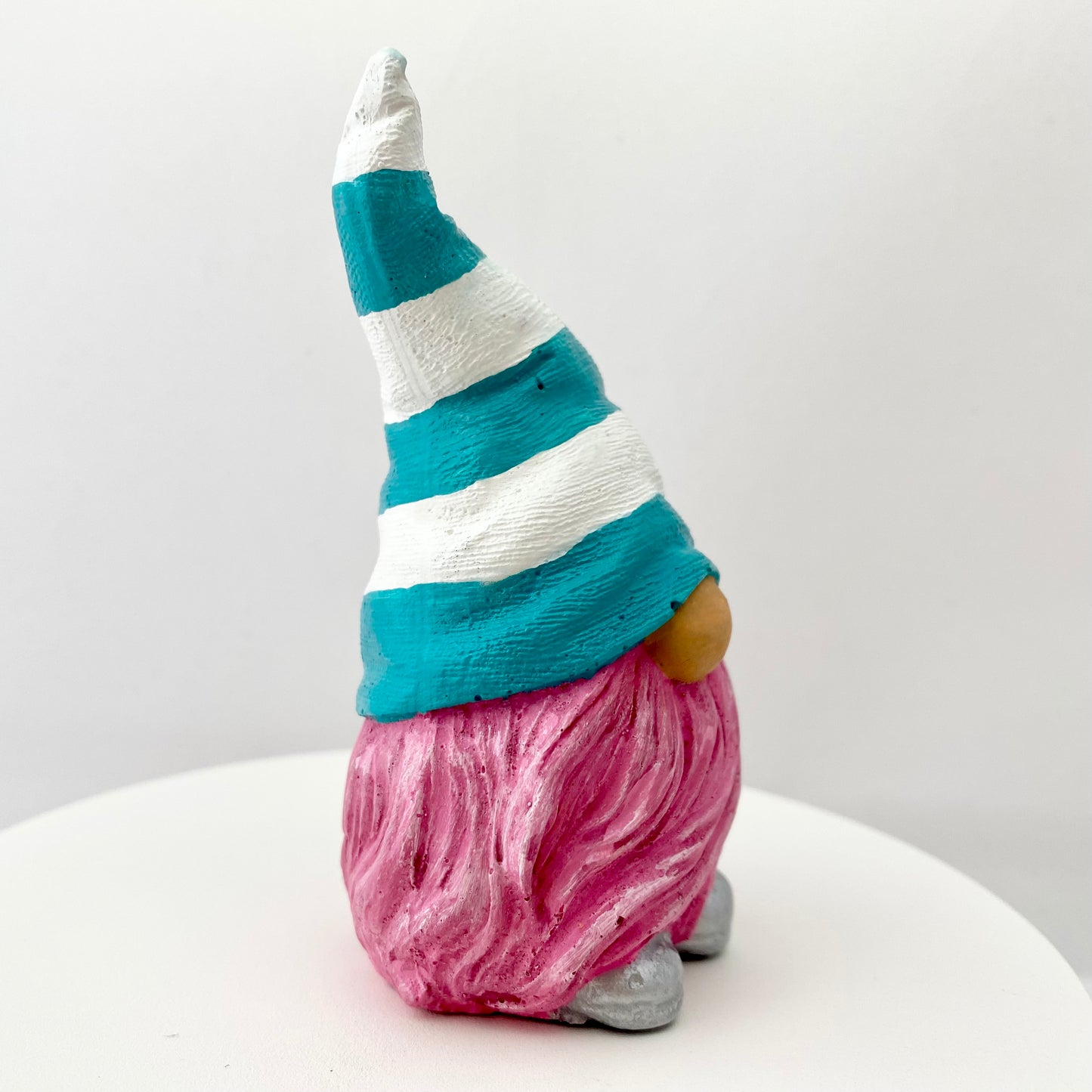 Hand painted Gonk statue with pink beard and teal and white striped hat  Edit alt text