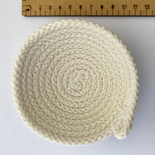 Small white rope bowl next to a ruler