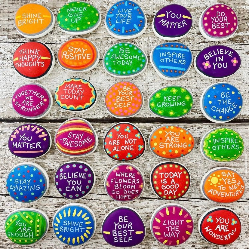 Lots of Colourful Hand painted pebbles with uplifting affirmations written on