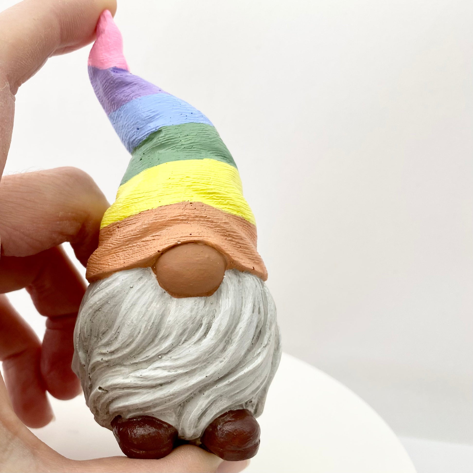 Hand painted Gonk statue with pastel rainbow striped hat