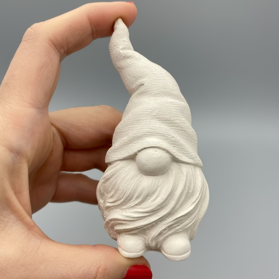 Small white hand Cast Plaster Gonk Statue ready to paint. Held to show size.