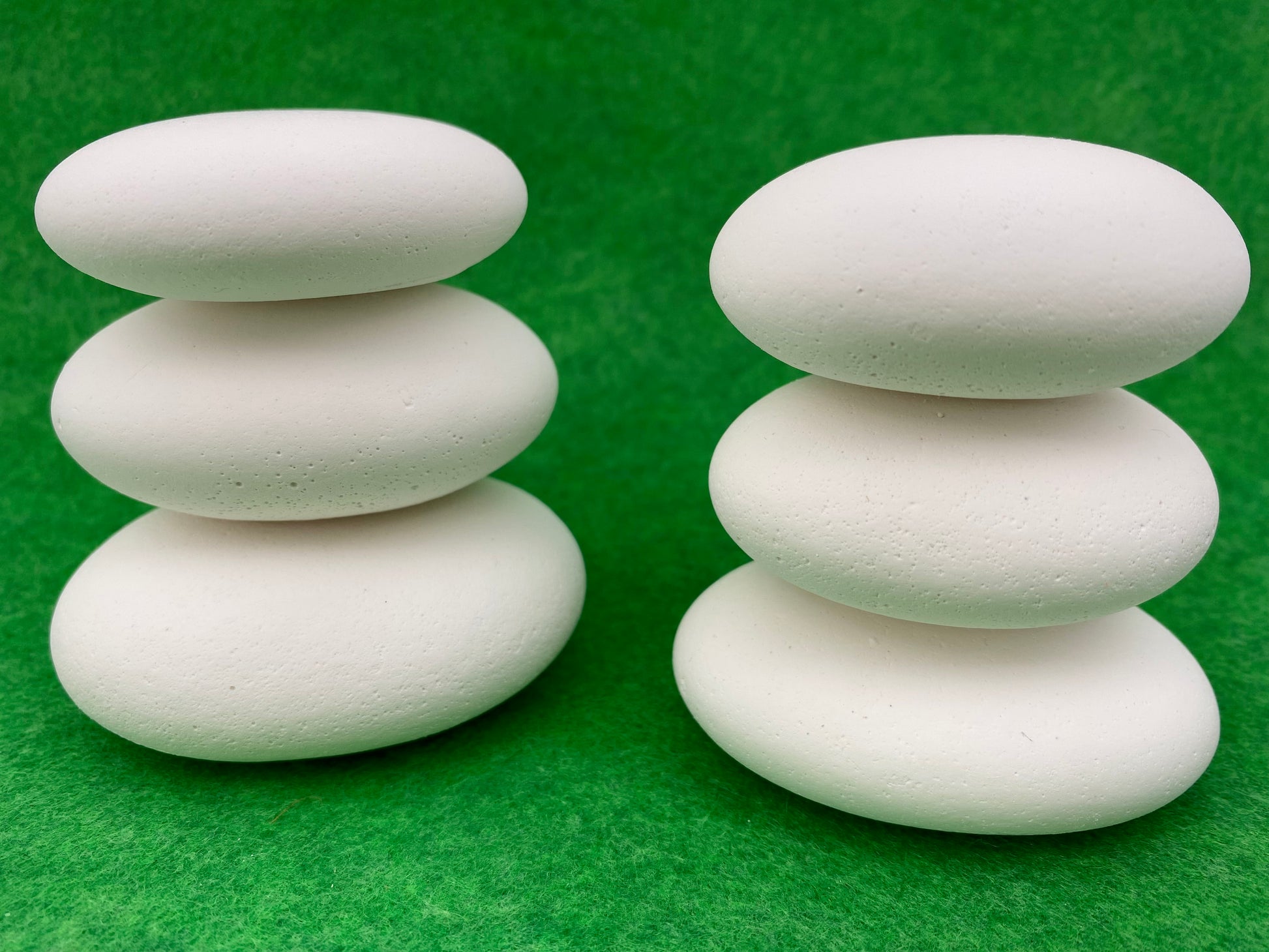 6 Large white plaster pebbles stacked on top of each other