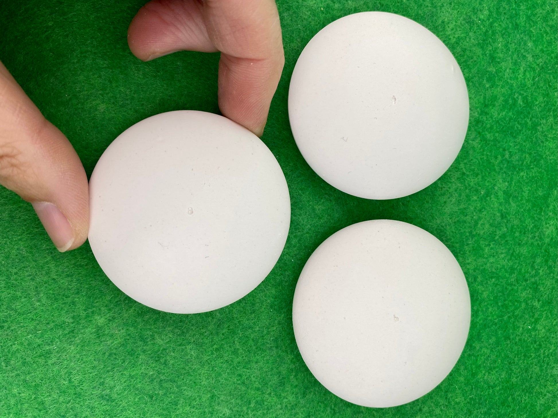 5cm white circular plaster pebbles, each with a tiny centre hole to help with painting mandalas. Photographed with a hand