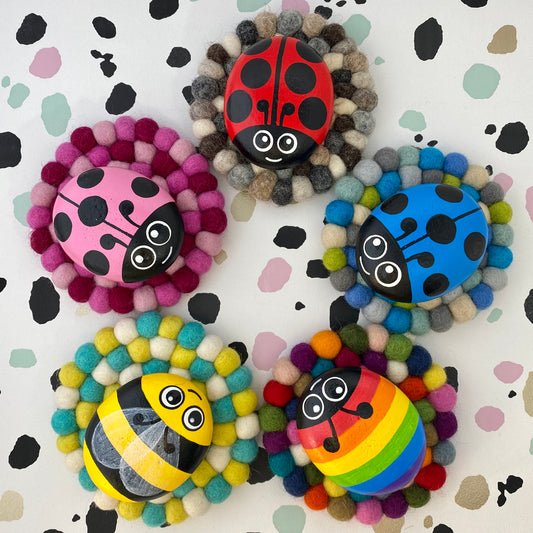 Coaster sized Mats made from colourful Felt Balls with Hand painted Rock Bugs on top