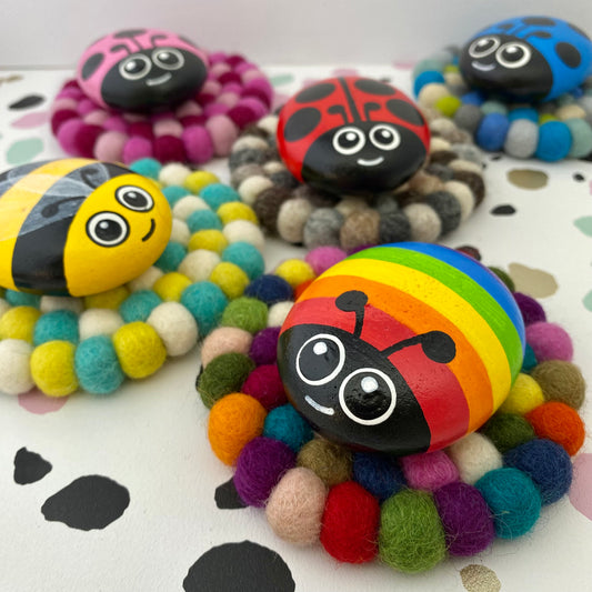Coaster sized Mats made from colourful Felt Balls with Hand painted Rock Bugs on top
