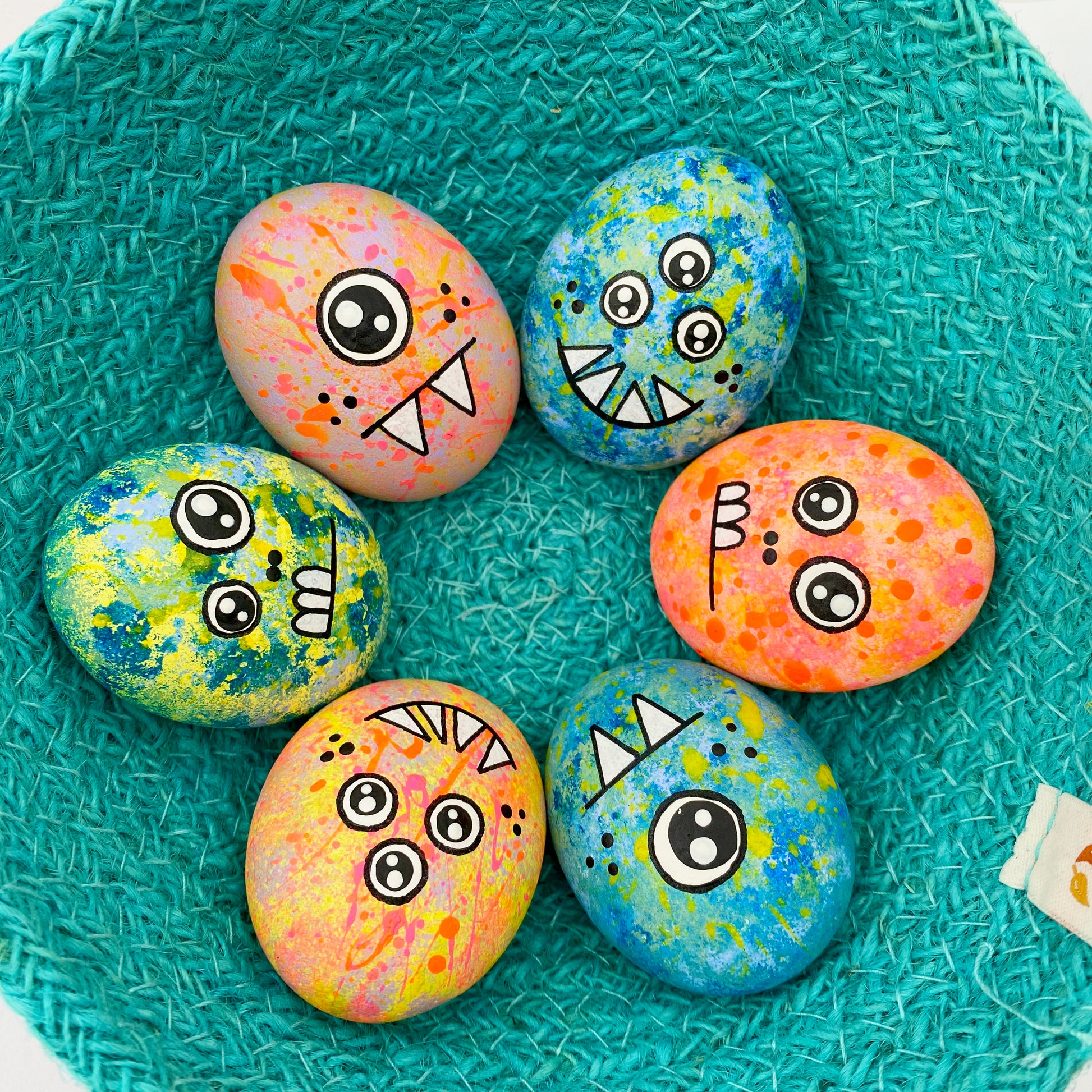 Lots of hand painted Pocket Monster pebbles in a bowl
