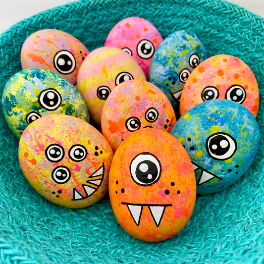Lots of hand painted Pocket Monster pebbles in a bowl