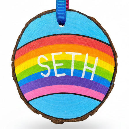 Hand painted hanging Wooden Slice with Rainbow background and name Seth painted on
