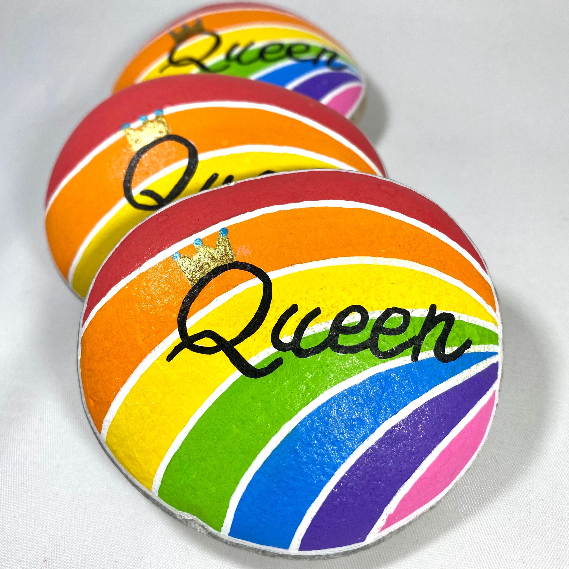 Hand painted Rainbow Stone Paperweight personalised with the word Queen and a Crown