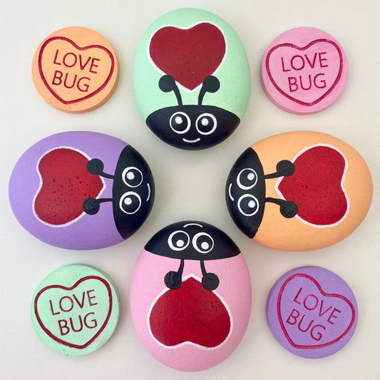 4 Hand painted Pastel Heart Bug Pebbles and Tokens with the words Love Bug inscribed on